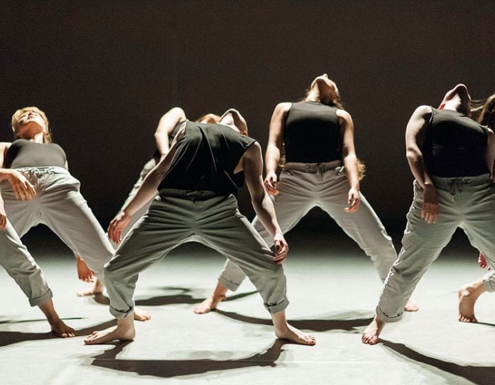 Dance students arching bodies backwards